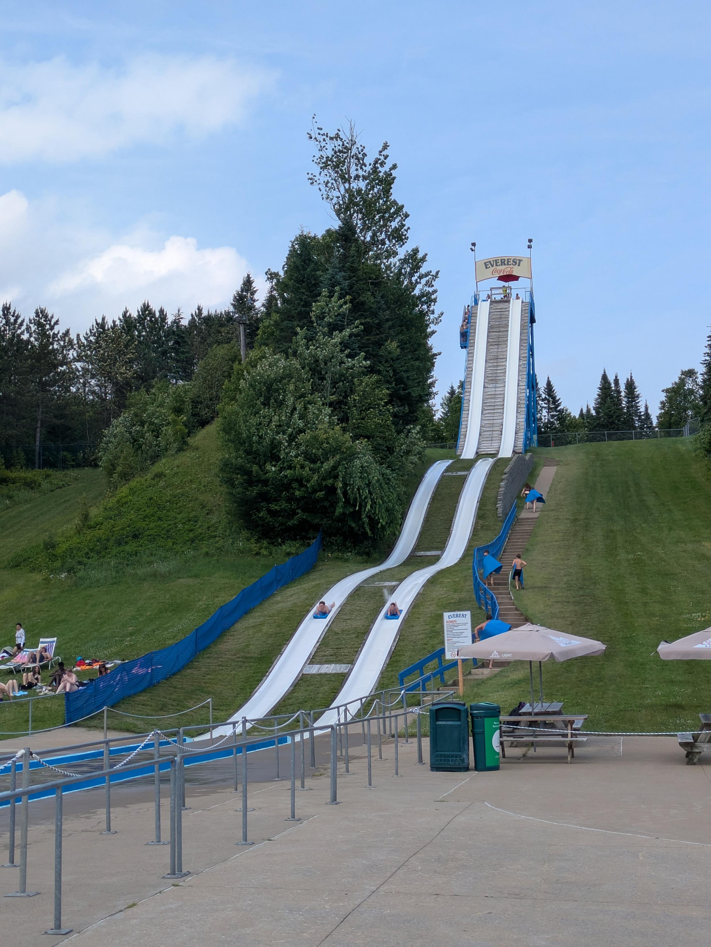 A very tall, as in hundreds of meters, water slide with two ramps that start almost fully vertical and then make two less steep slopes before the end.