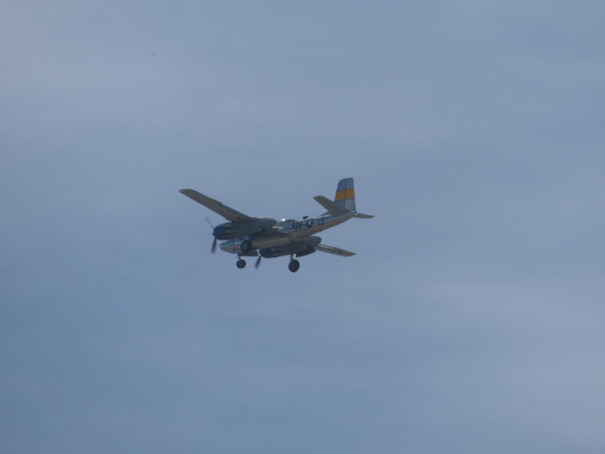 The same aircraft, flying away from the camera, landing gear now extended