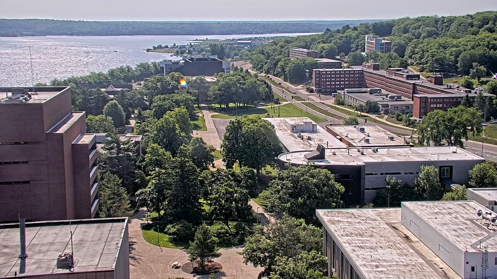 View looking east from the RL Smith Building overlooking the MTU campus and Portage Lake. // Image captured at: 2026-07-05 14:18:03 UTC (about 1 min. prior to this post) // Image sourced from: mtu.edu // Current Temp in Houghton: 64 F | 18 C // Precip: overcast clouds // Wind: E at 2 mph | 3 kph // Humidity: 78%