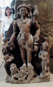 A sculpture group of the god Shiva depicted with an erect phallus. He is surrounded by four smaller figures.