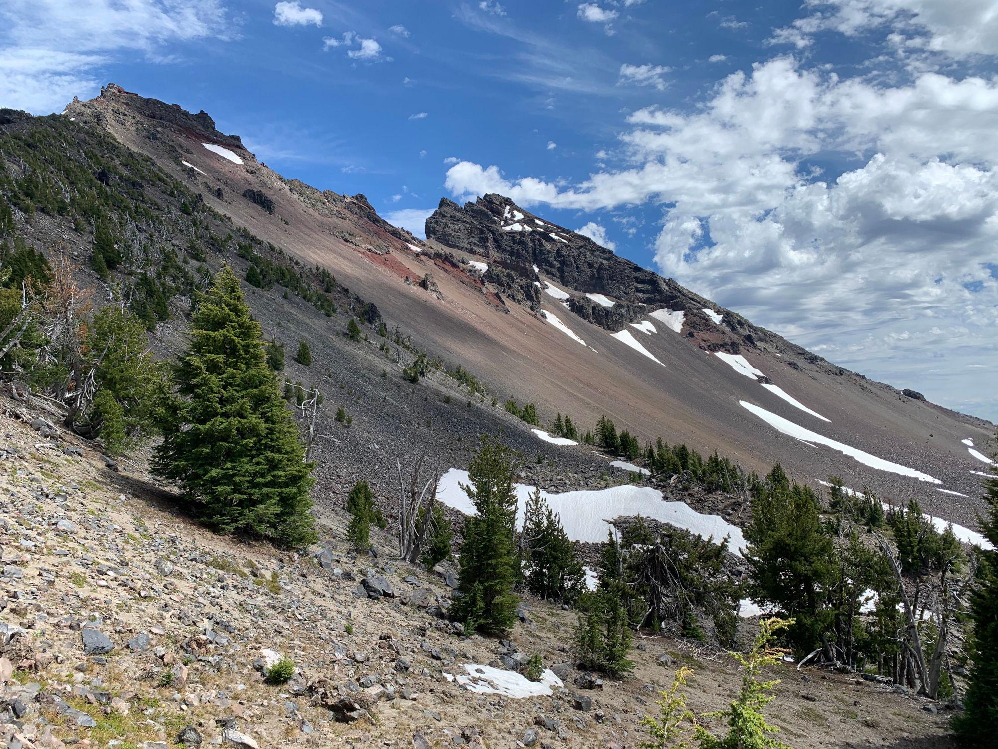 Partly cloudy skies drifting over Broken Top in the afternoon.