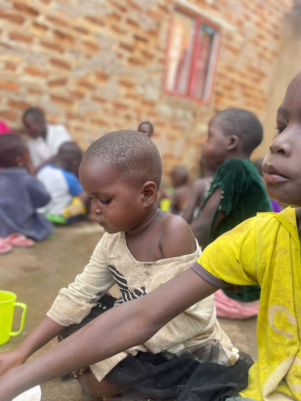 A moving photograph from a community feeding sessions ,In the photo, it's a group of streetkids and orphans enjoying a warm meal together, This image shows the real, everyday impact of Outreach Ministries on the ground—proving that a small donation or boost can directly provide the next life-saving meal for these vulnerable children.