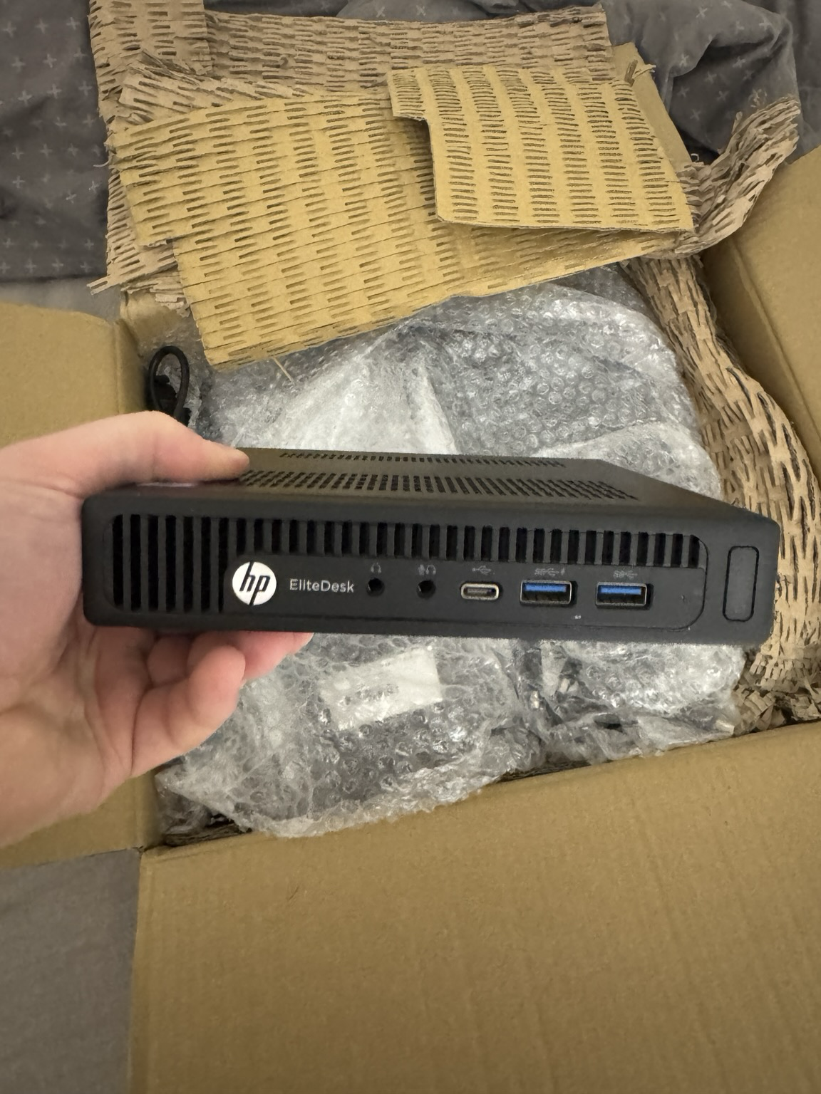 A picture displaying the front of a HP EliteDesk Mini