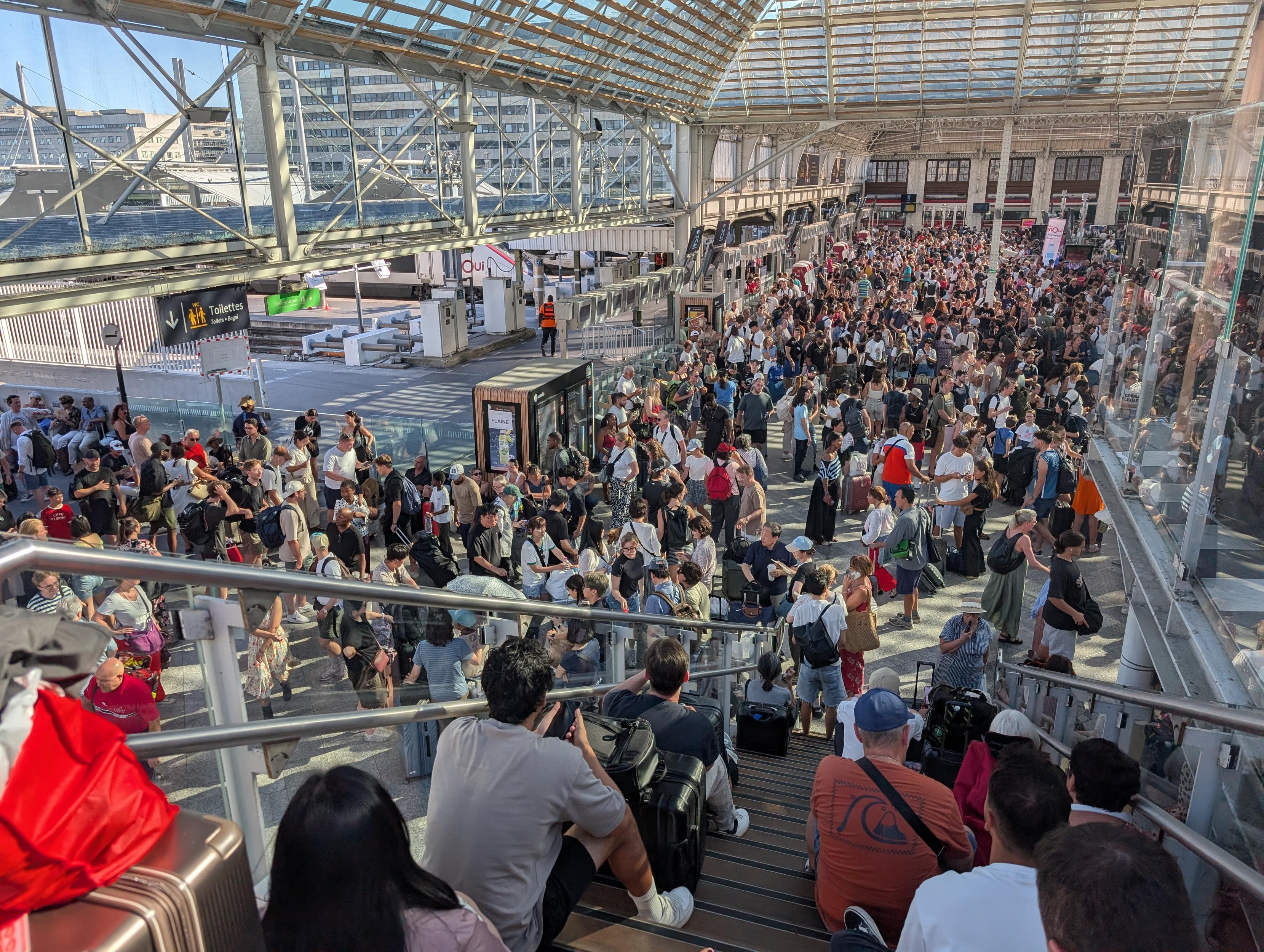 People sitting on the stairs above the Hall 2.