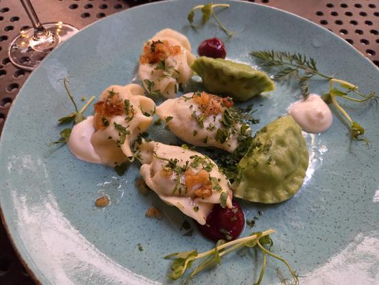 Six delicious pierogis on a plate.