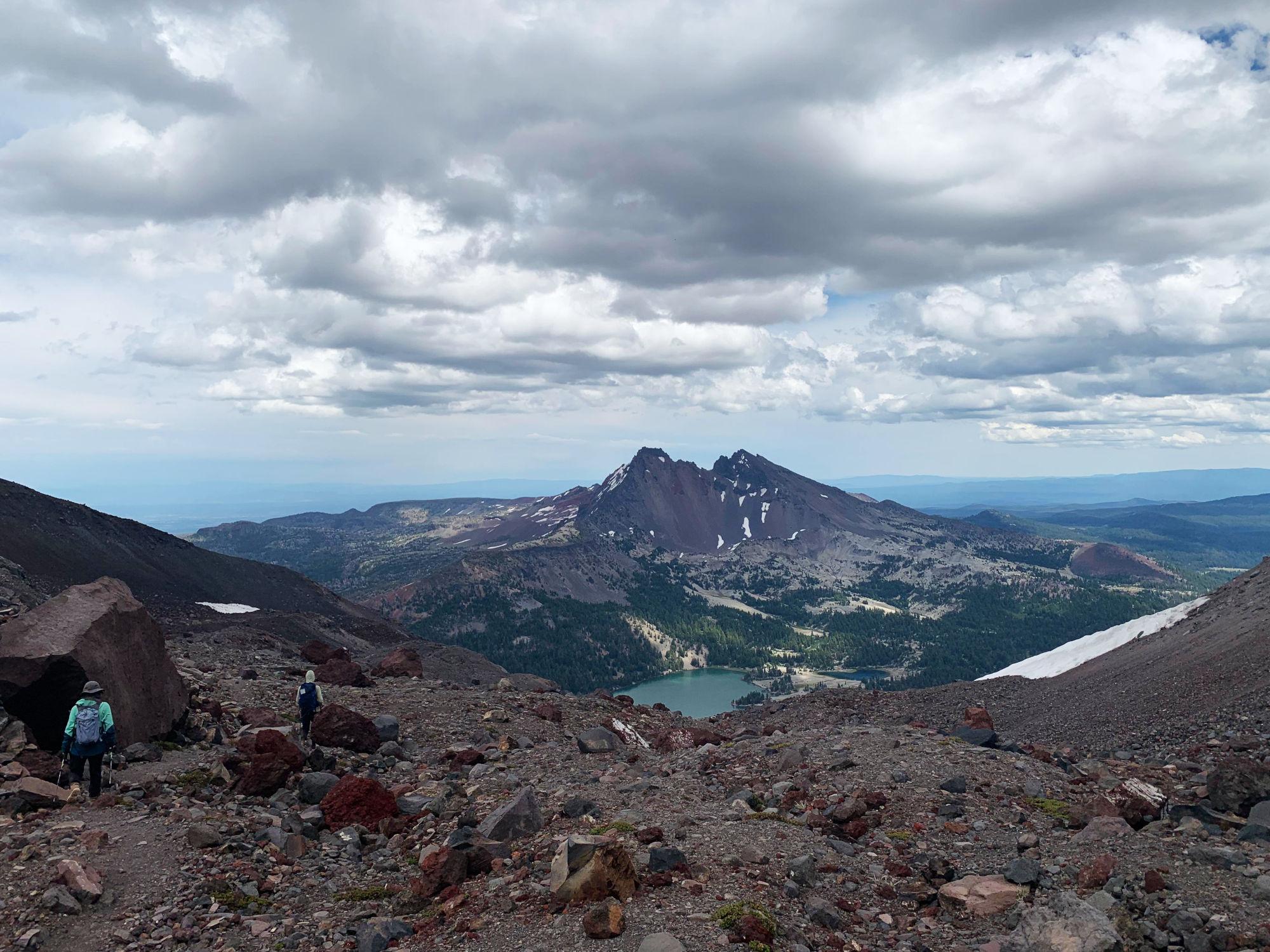On the way down, looking toward broken top, with Green Lake down below in front of it.