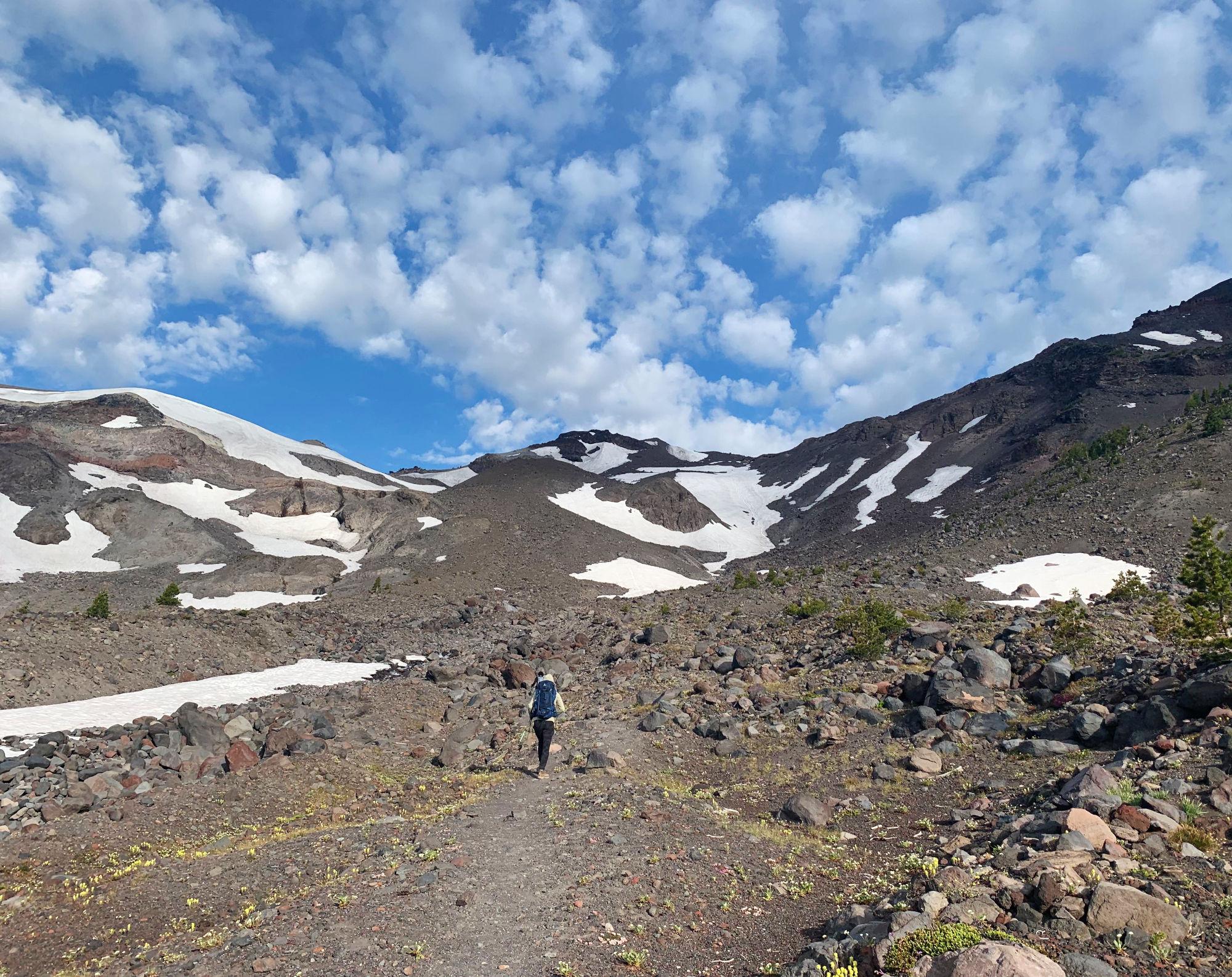 On the way up, scattered snow fields, and lots of rubly slopes under patchy clouds
