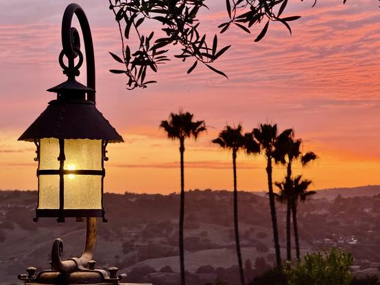 Red cloud sunset with lamp in the foreground.