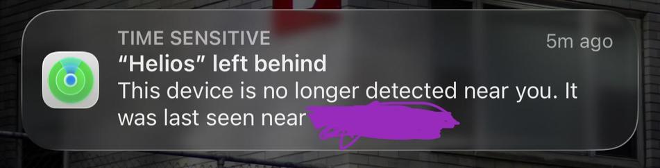An iOS notification from Find My that reads, ‘Time Sensitive: “Helios” left behind. This device is no longer detected near you. It was last seen near [redacted].”