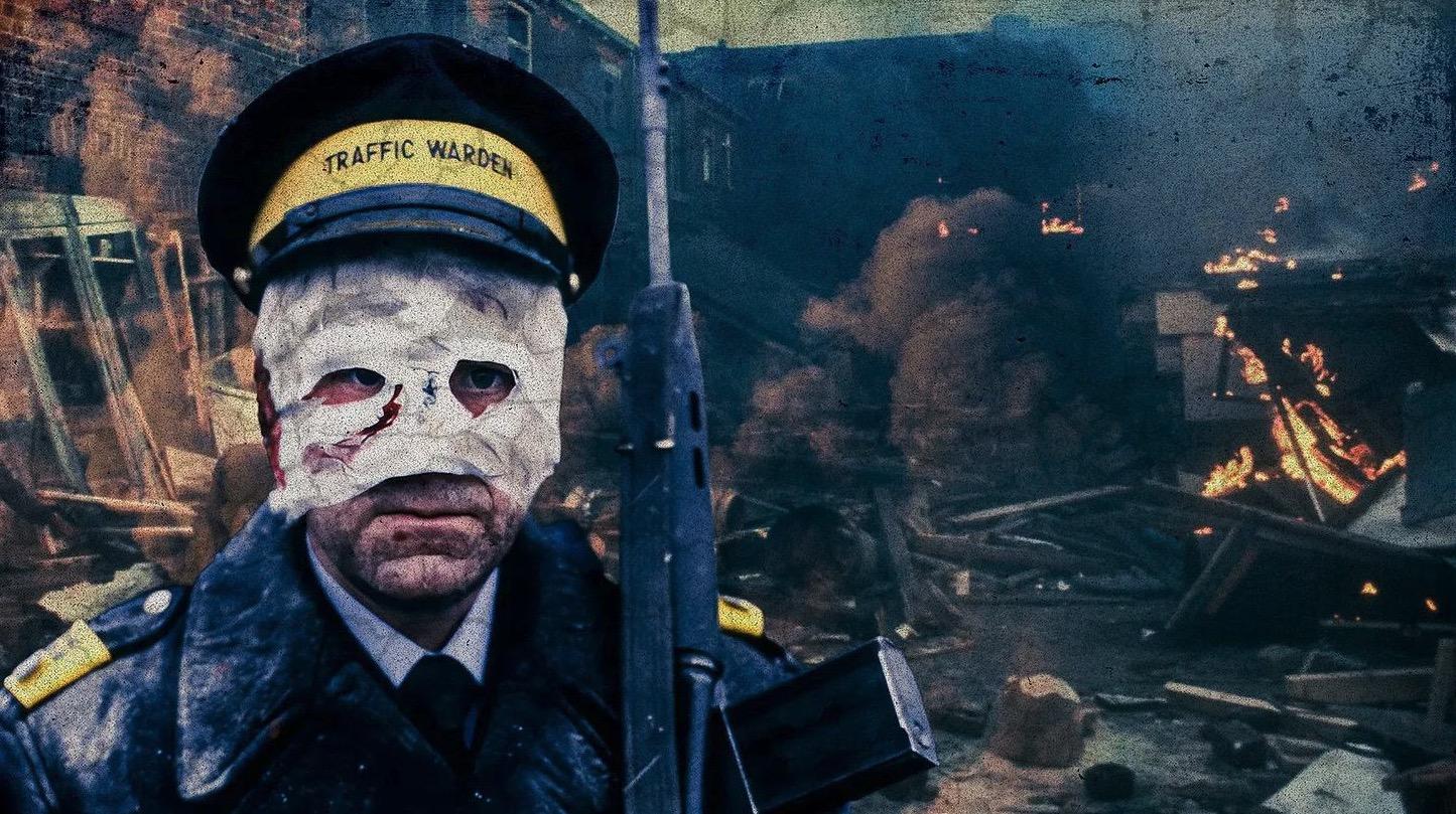 A scene is Threads depicting an injured traffic warden with a rifle and a bandage covering most of his face, wreckage in the background