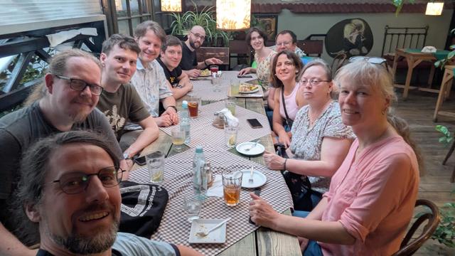 table with several people looking in camera