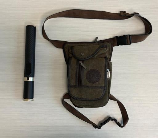 To the left a selfie stick that I wish you'd confuse with a lightsaber,  to the right, a green canvas leg bag which ties around my waist and my leg