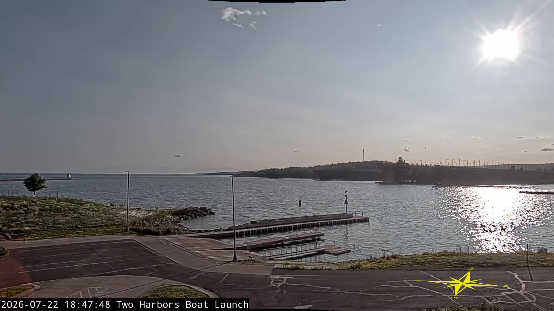 View looking west of the Two Harbors Boat Launch into Agate Bay and Lake Superior. // Image captured at: 2026-07-22 23:48:12 UTC (about 1 min. prior to this post) // Image sourced from: youtube.com/@DuluthHarborCam1 // Current Temp in Two Harbors: 74 F | 23 C // Precip: broken clouds // Wind: SSW at 3 mph | 6 kph // Humidity: 50%