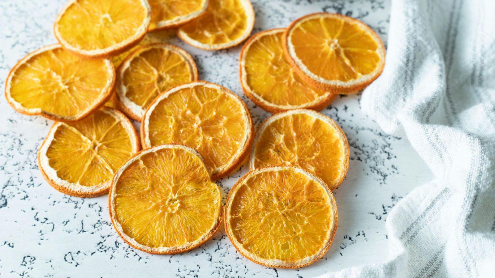 Tray of dehydrated orange slices with translucent edges and bright color
