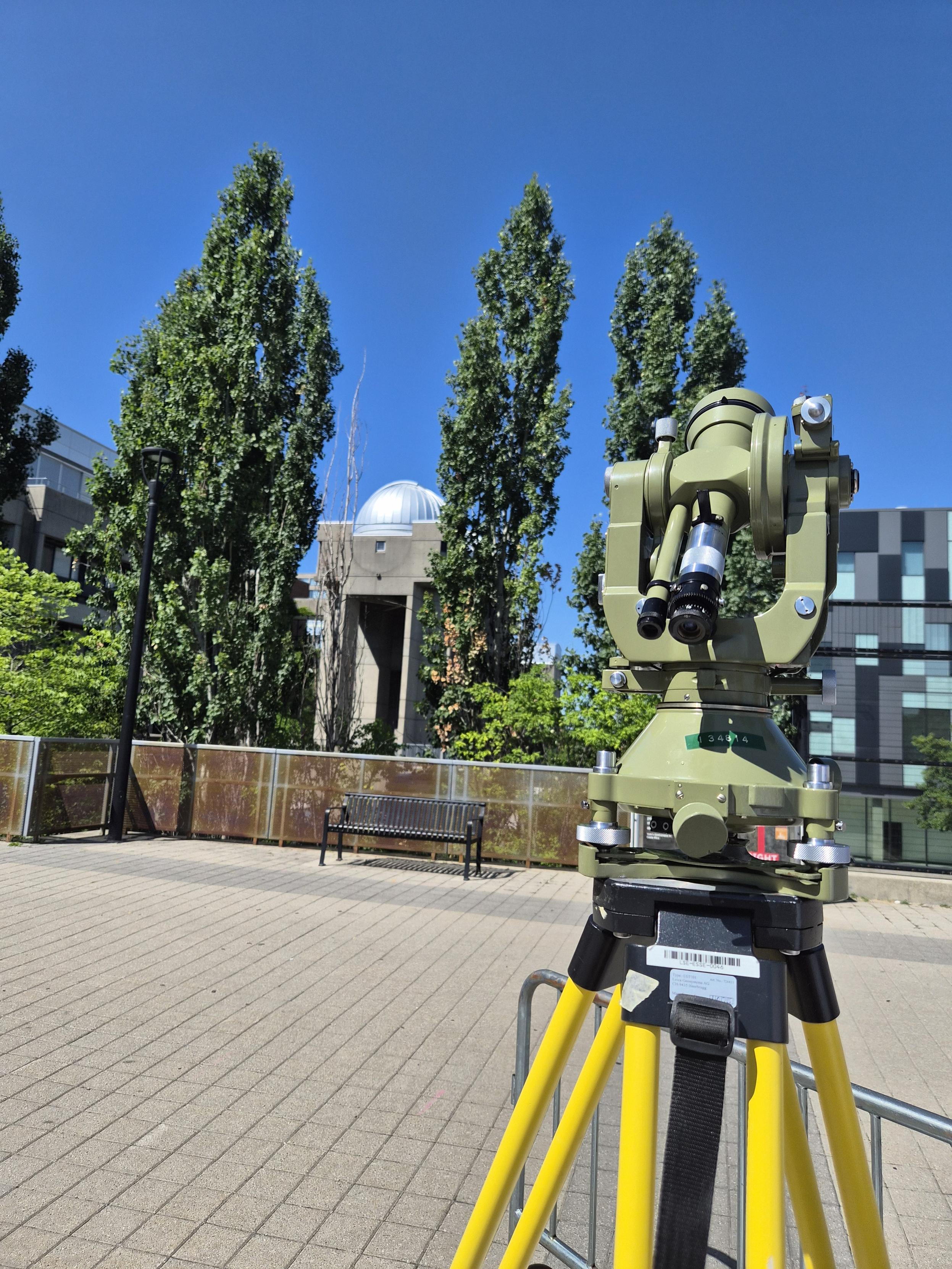 T3 survey telescope atop the sundial pier with the Allan I Carswell Observatory in the background, the T3 is mounted on a yellow tripod and is not yet aligned to the sun.