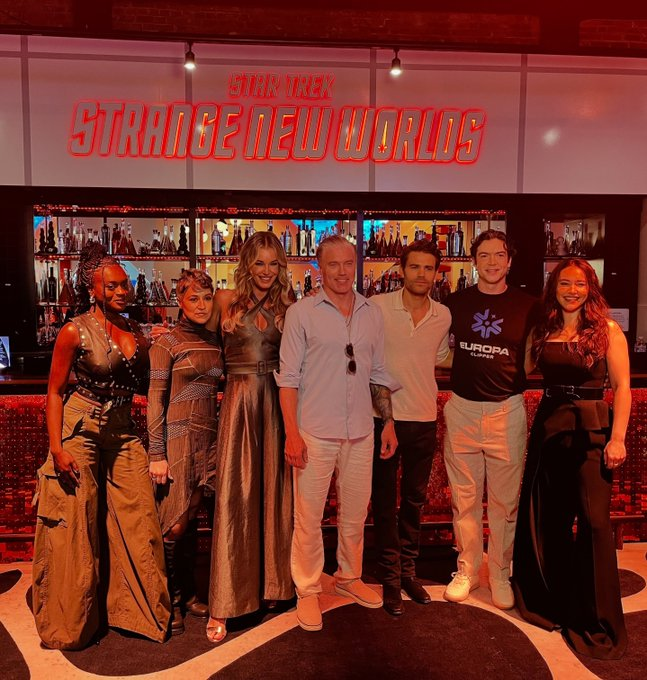 The SNW cast in front of the SNW Display at SDCC: Celia Rose Gooding, Melissa Navia, Rebecca Romijn, Anson Mount, Paul Wesley, Ethan Peck, Christina Chong.