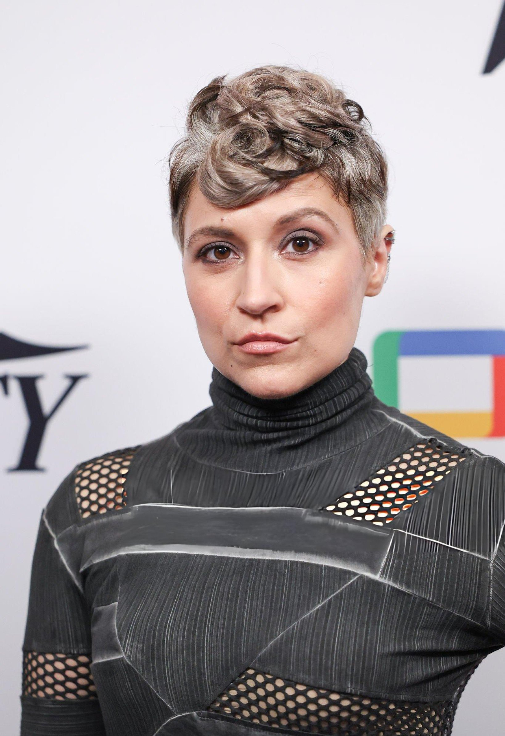Melissa Navia at "Variety Studio" at SDCC: She wears a back and silver dress with mesh-panels. I looks like it's maybe inspired by Star Trek ship design. Her shrt hair is styled in different shades of grey and cute curls.