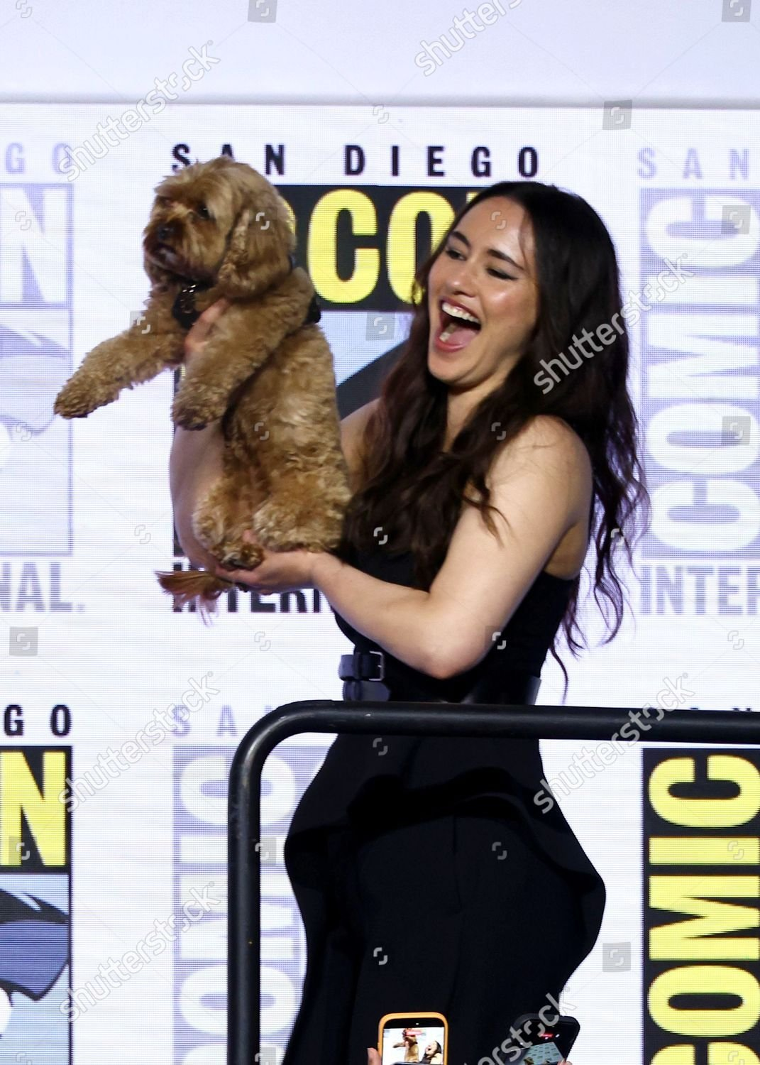Christina Chong holds up her dog Runa and presents her laughing to the audience of Hall H.