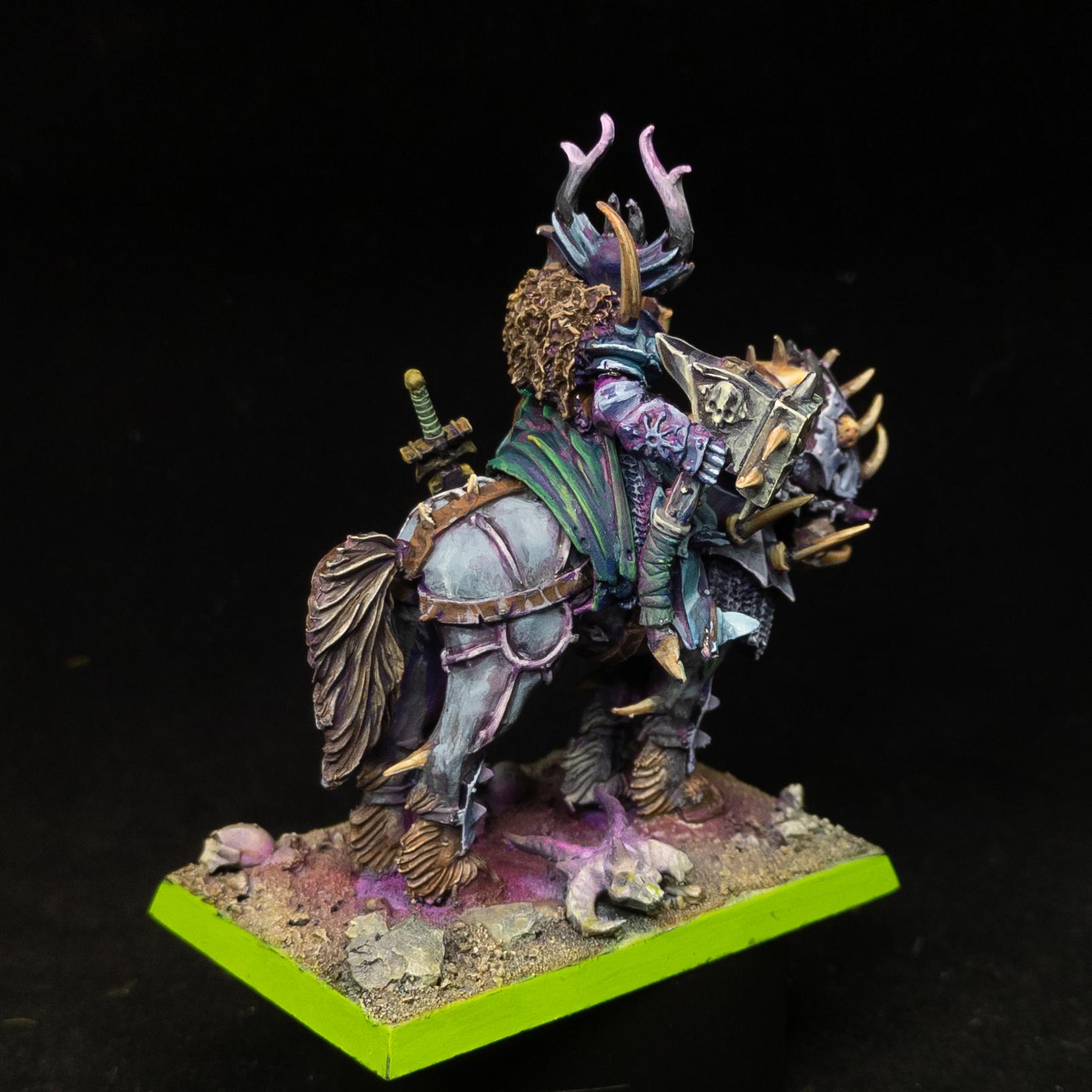 Chaos Lord in grey and blue armour, with a green shield, purple scabbard, on a steed in the grey and gold armour. Rear shot.