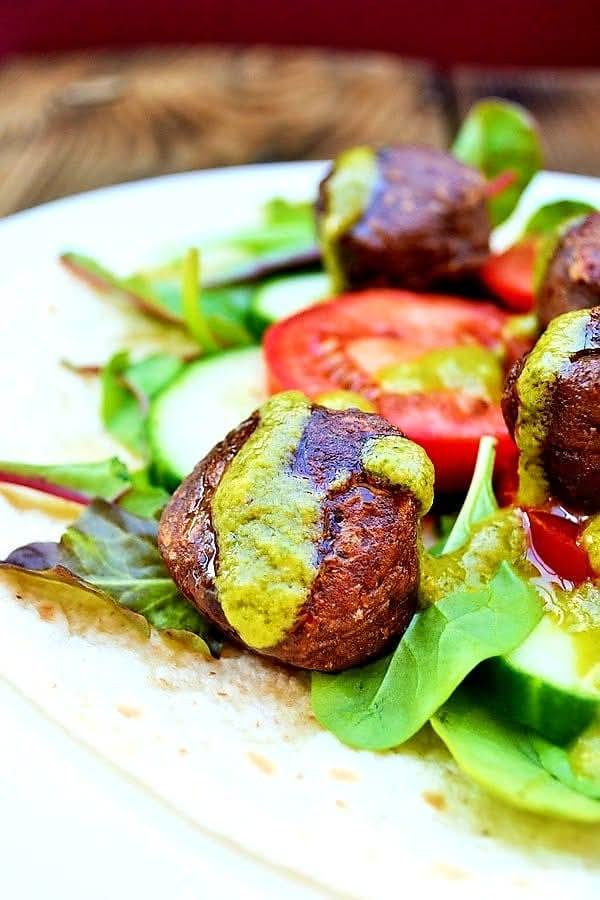 Kidney bean falafel on a wrap with salad and a green sauce