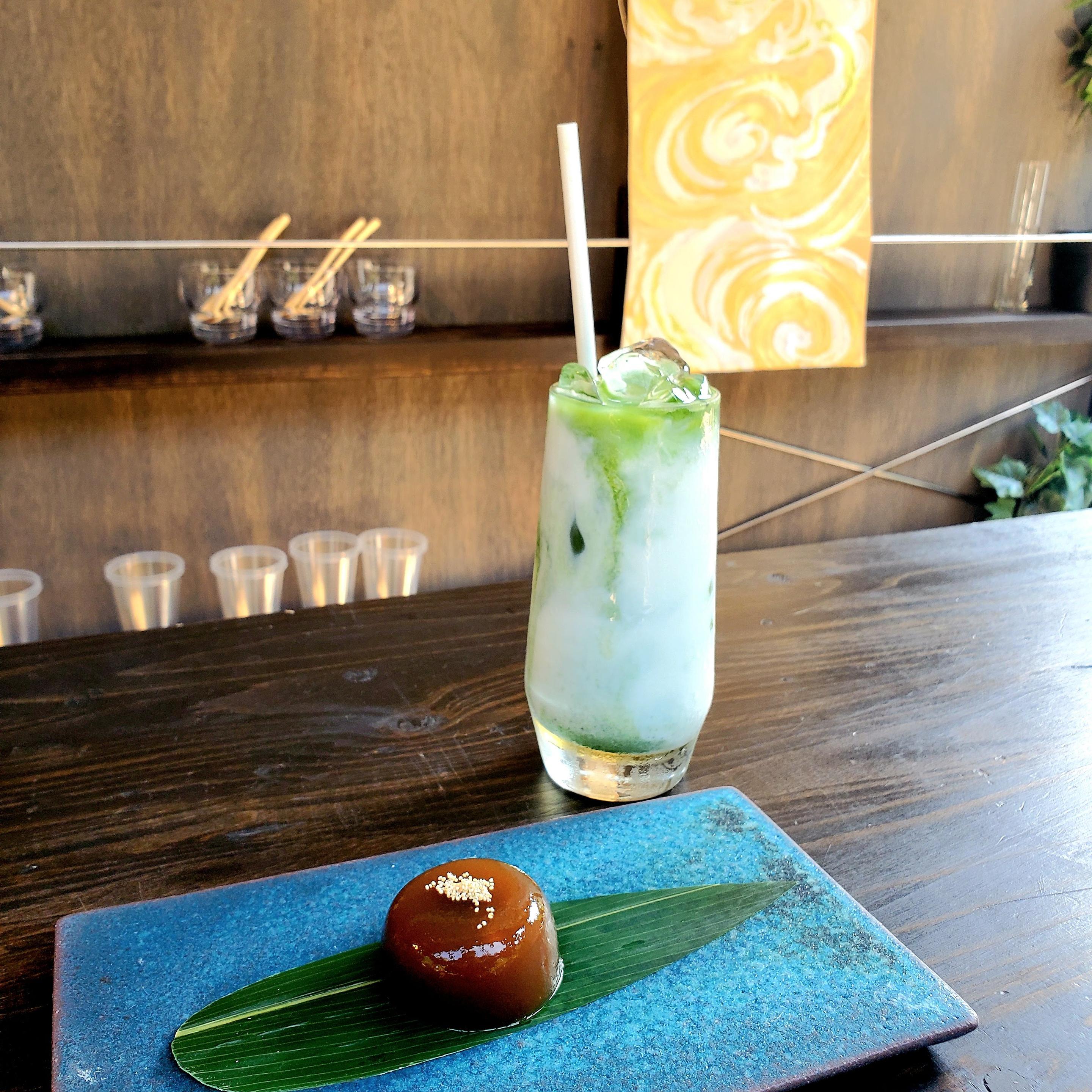 Iced matcha latte accompanied by ubatama (balls of red bean paste and muscovado sugar covered in an agar jelly).