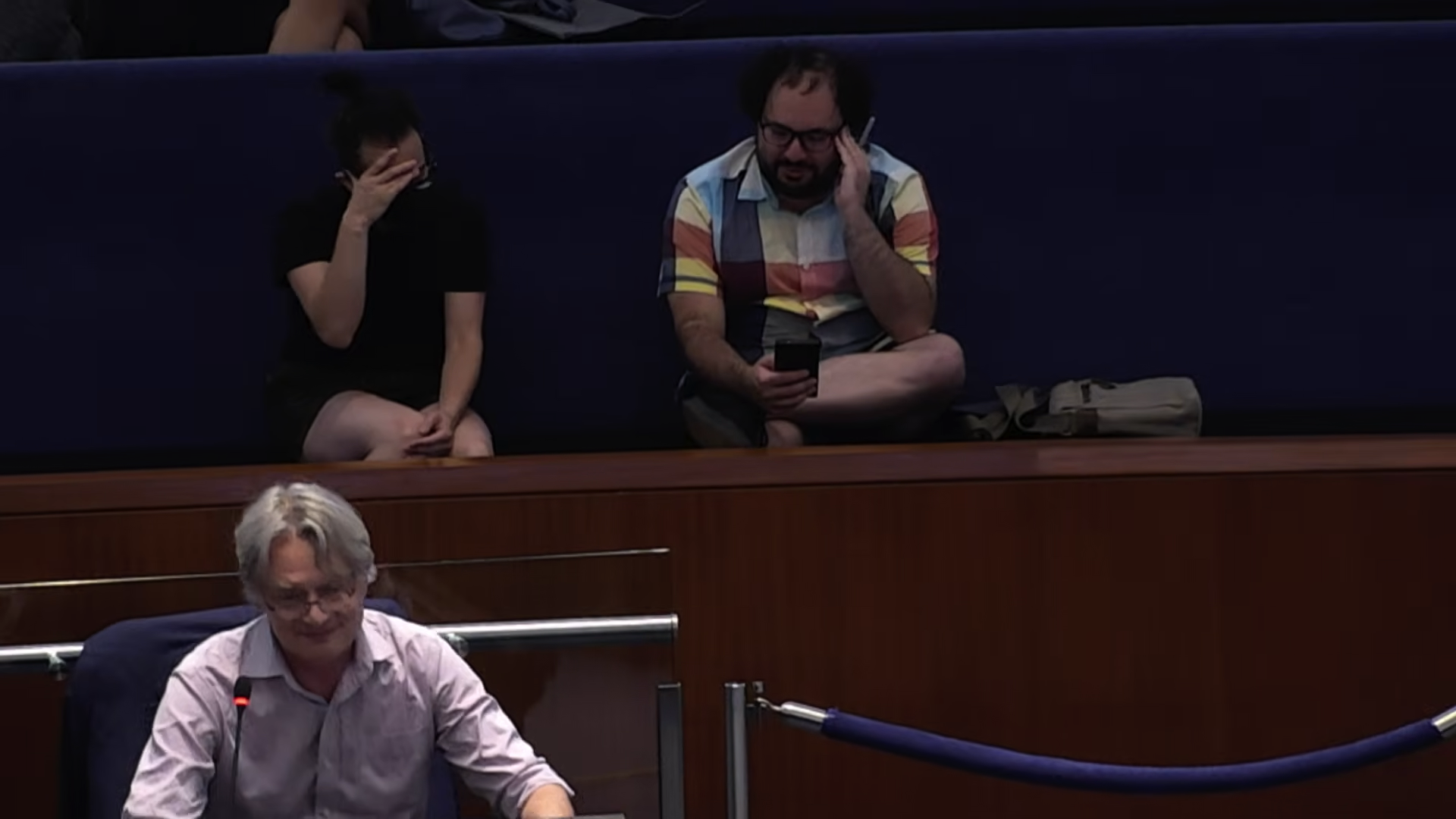 Neville Park in black T-shirt and black mask, Goldsbie in colourful plaid shirt, both hiding our faces in embarrassment as Perks beams in the foreground (Thanks to Neville for providing this alt text.)