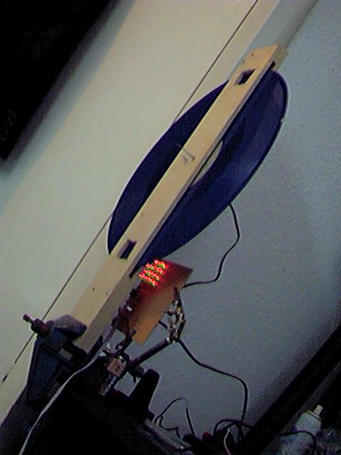 A 640x480 potato vision shot of a record mounted in a thin wooden frame in front of some red LEDs. Taken with my first digital camera, a Panasonic NV-DC1000