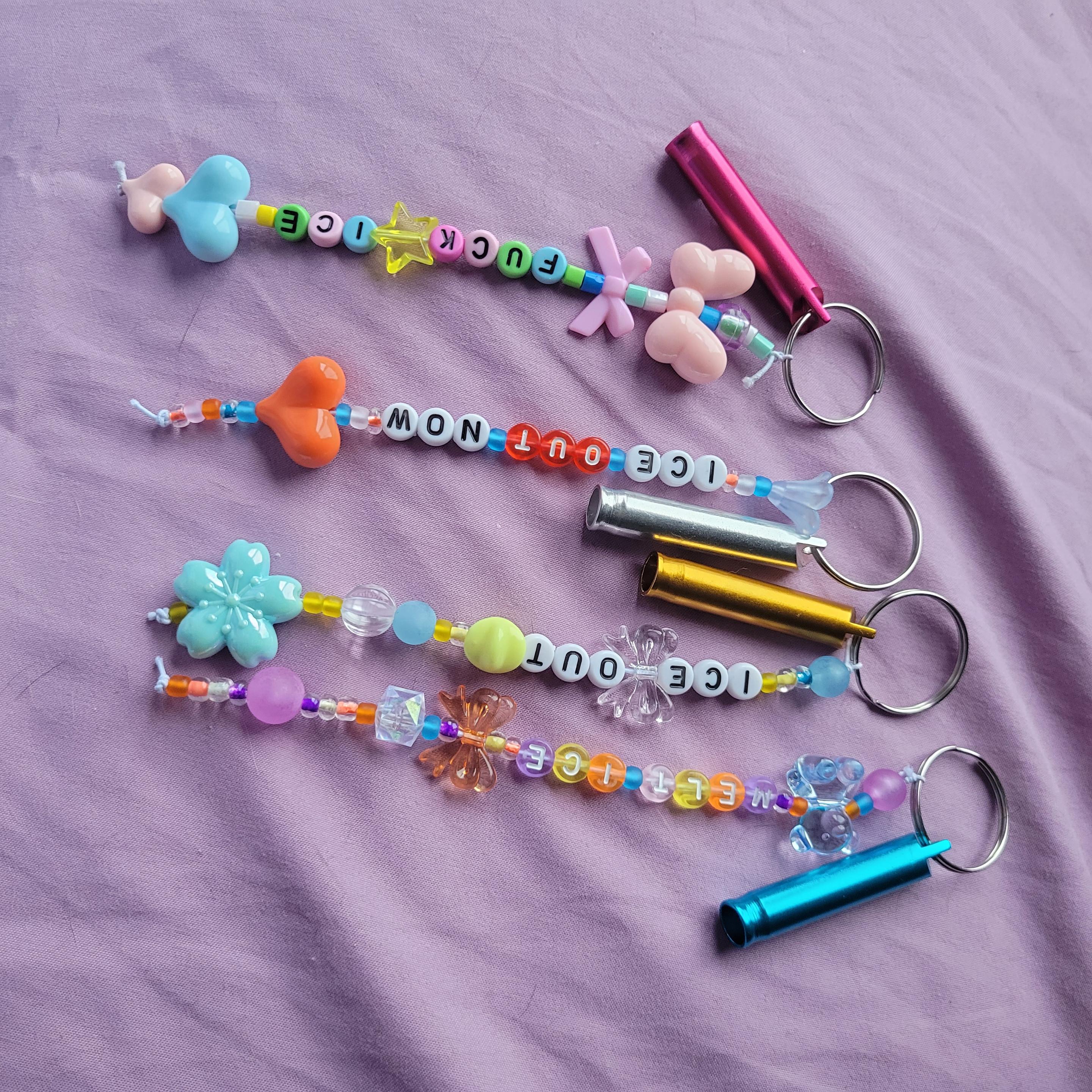 4 different keychains with whistles for an anti 🧊 protest