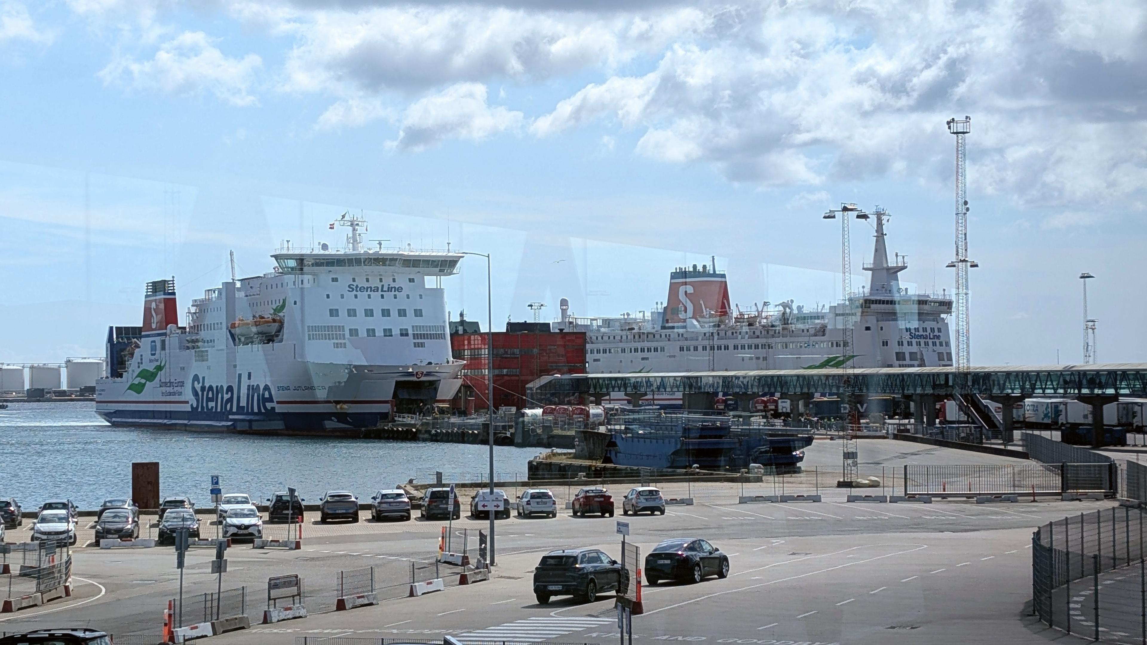 Ferry Stena Jutlandica in the port, many parked cars in the area in front of the dock