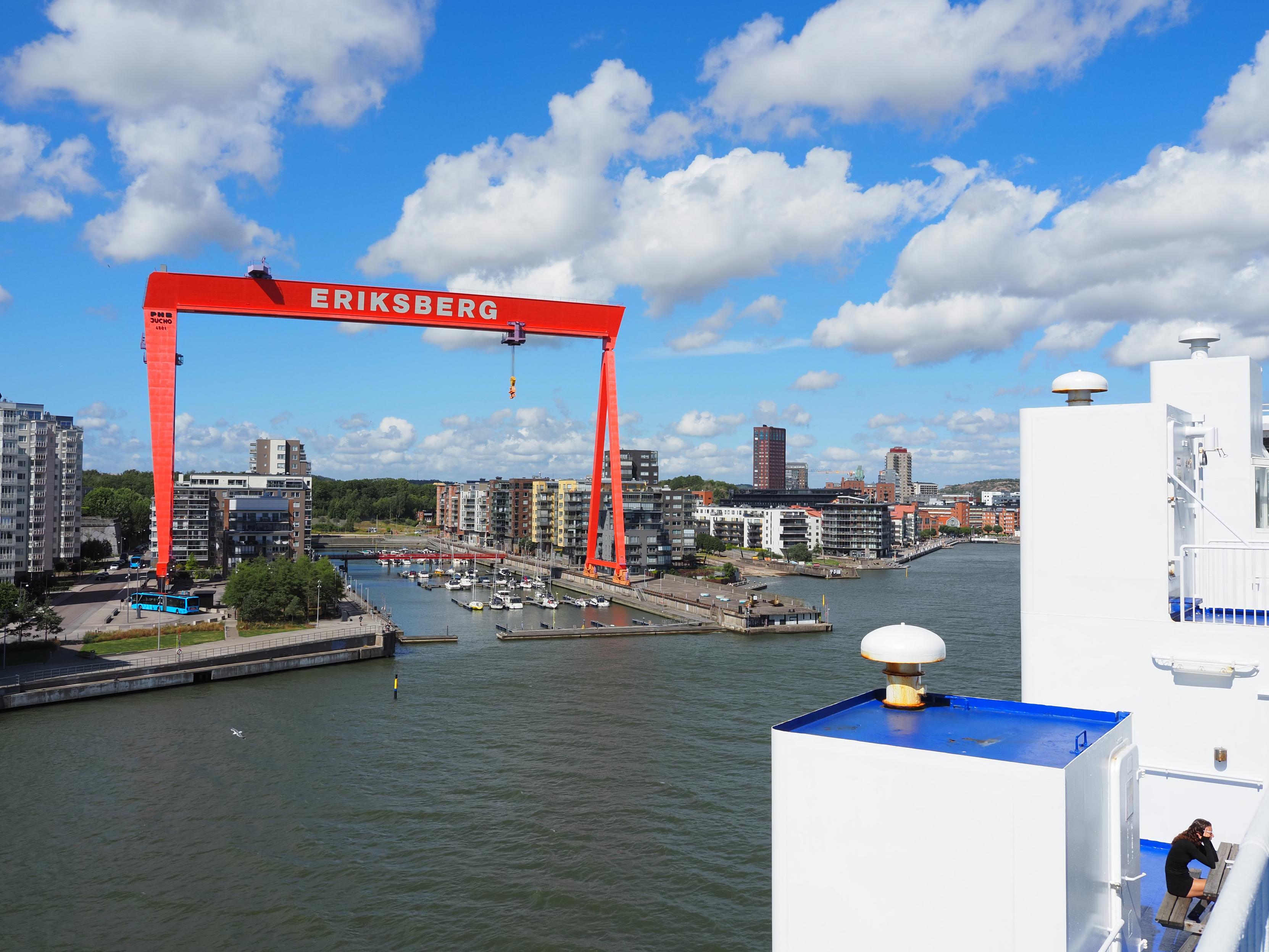 Modern residental buildings at a port for small boats, a red crane