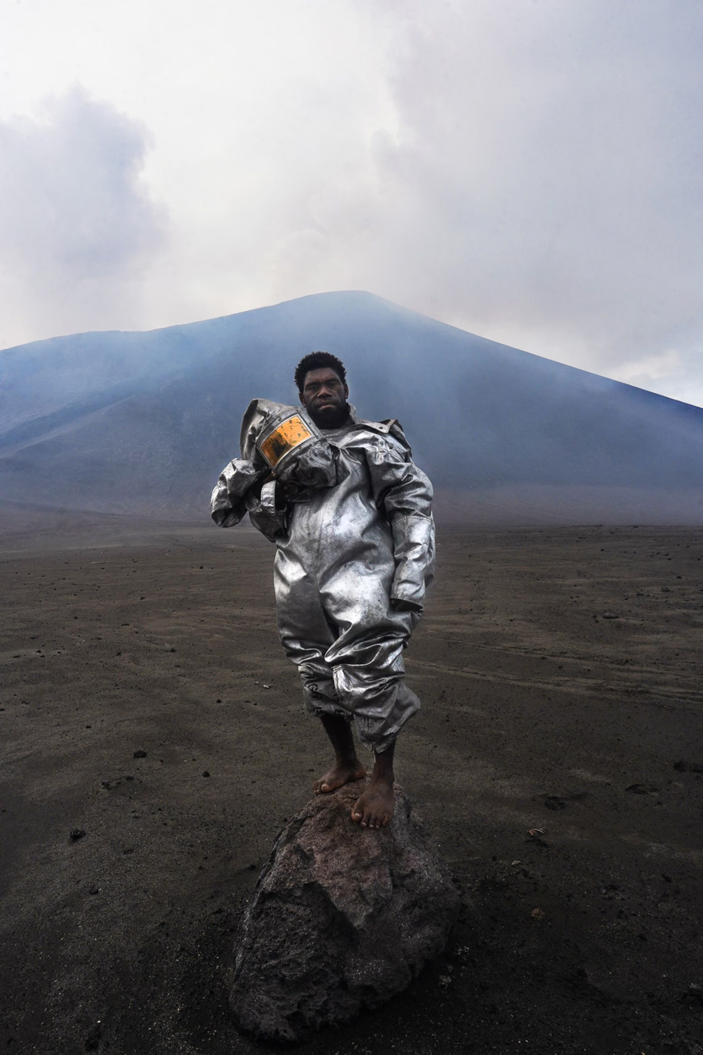 Having grown up in the shadow of this active volcano, Phillip is portrayed here in his natural element.
He is barefoot because his feet are size 20 and no shoes fit him so he does all his work barefooted.’ – Elle Leontiev