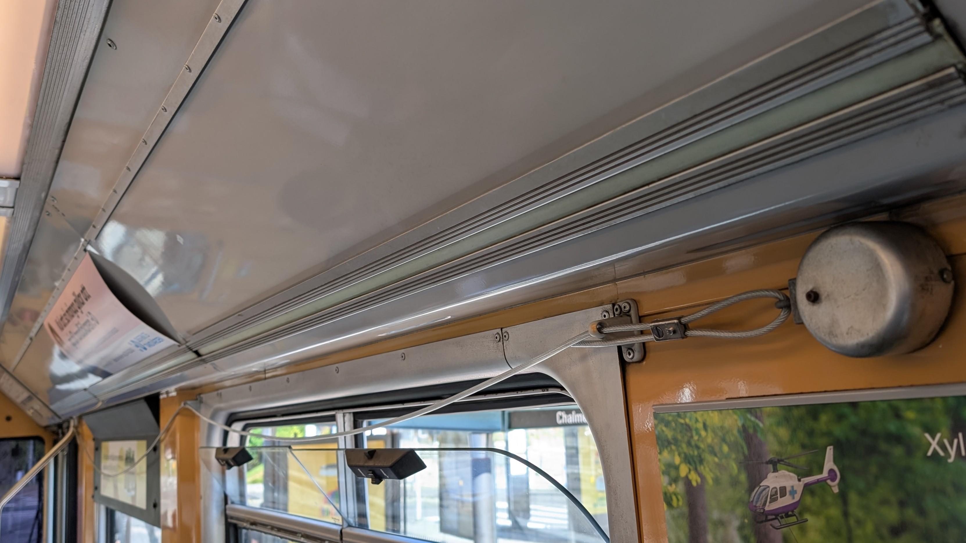 A string span above windows, a round bell at the end