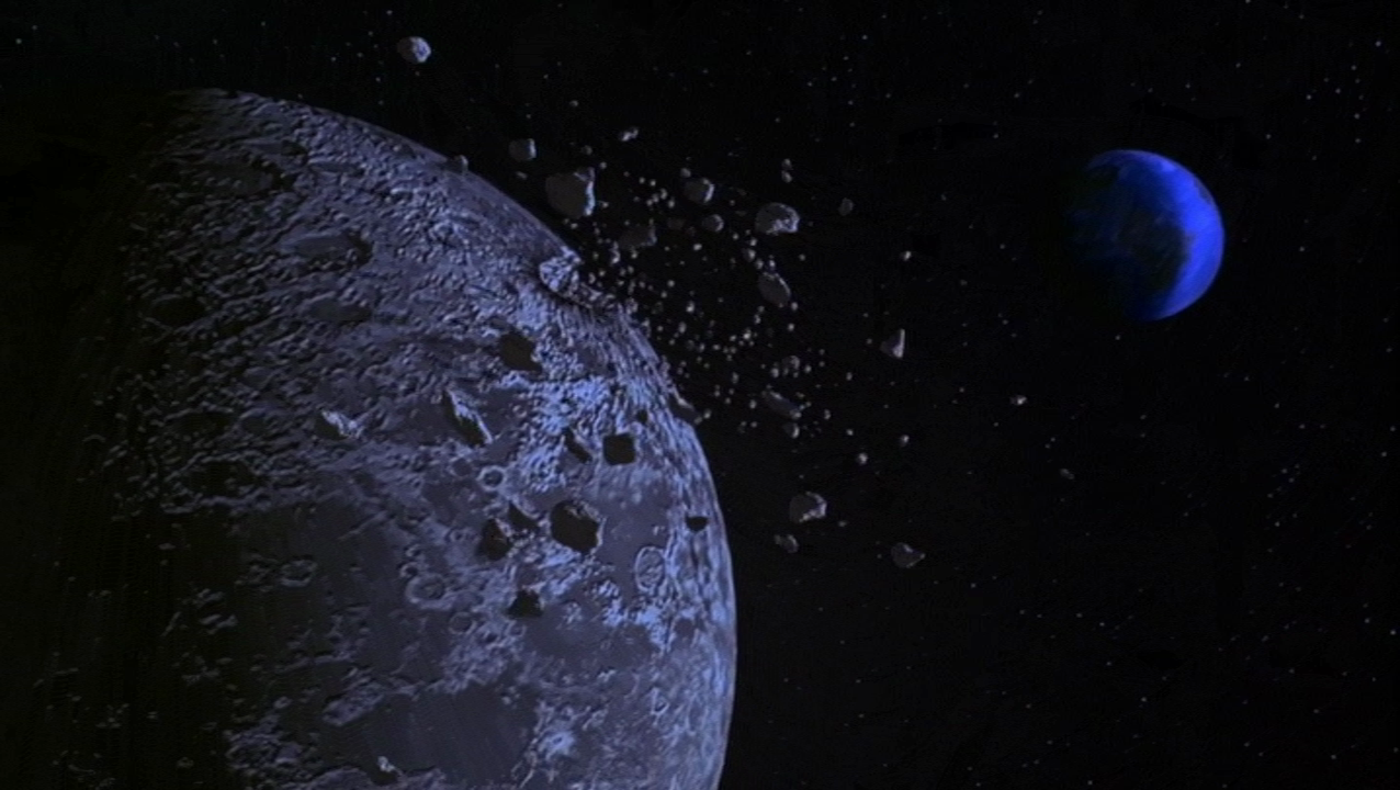 Screen grab from the film Coneheads, when their ship crazes the moon knocking a bunch of rubble into space.