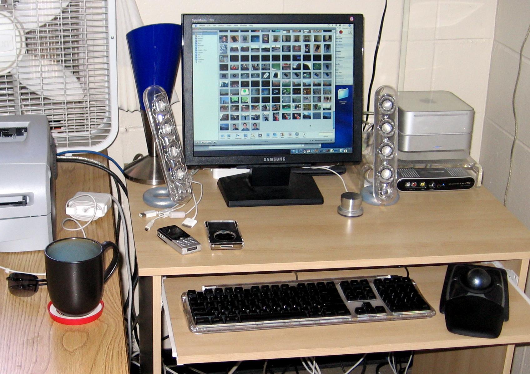 Mac mini on a small IKEA desk with SoundSticks speakers and a Samsung monitor