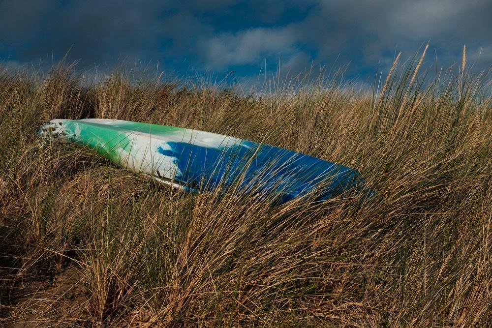 Upturned kayak in the long grass