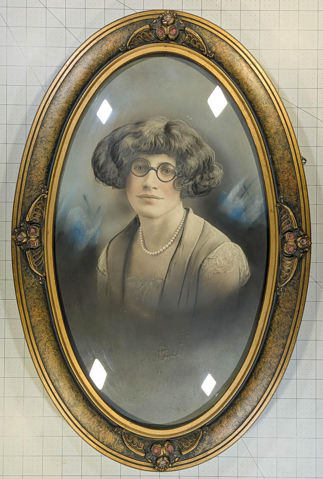 Crayon portrait of Dorothy Bridge 1912-27 (15) with a wide bob haircut and round glasses like Harold Lloyd in a decorative bubble glass frame