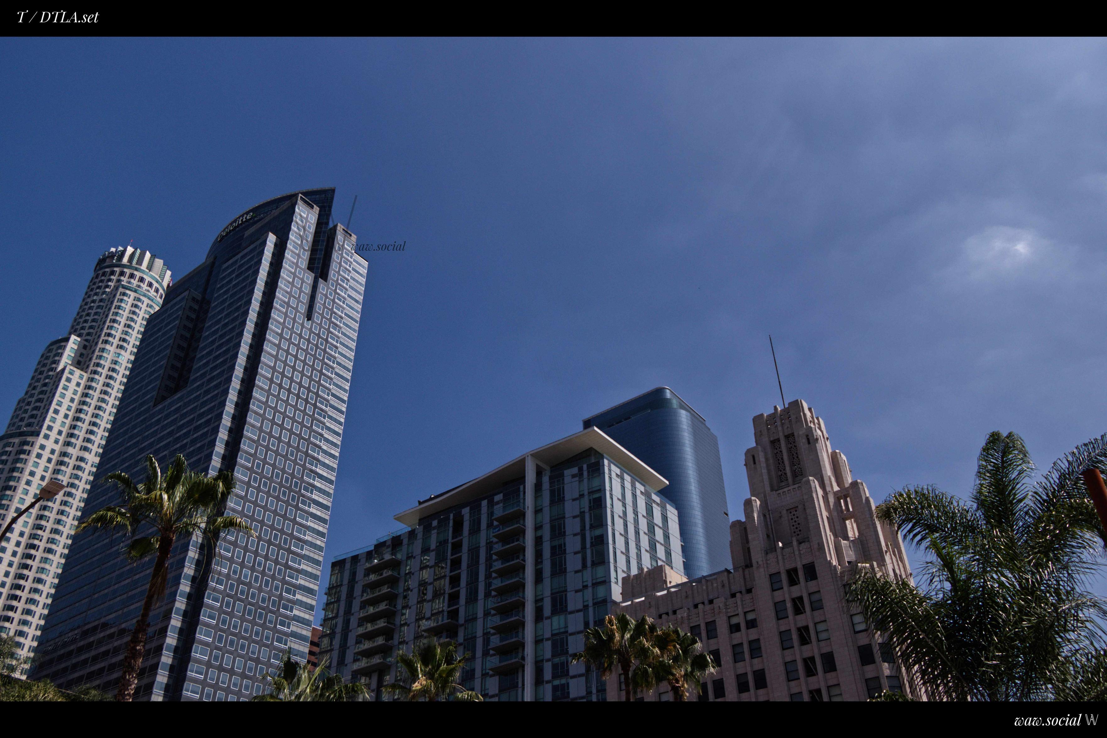 A cool color photo of buildings in Downtown Los Angeles with the US Bank Tower and Gas Company Tower in frame.