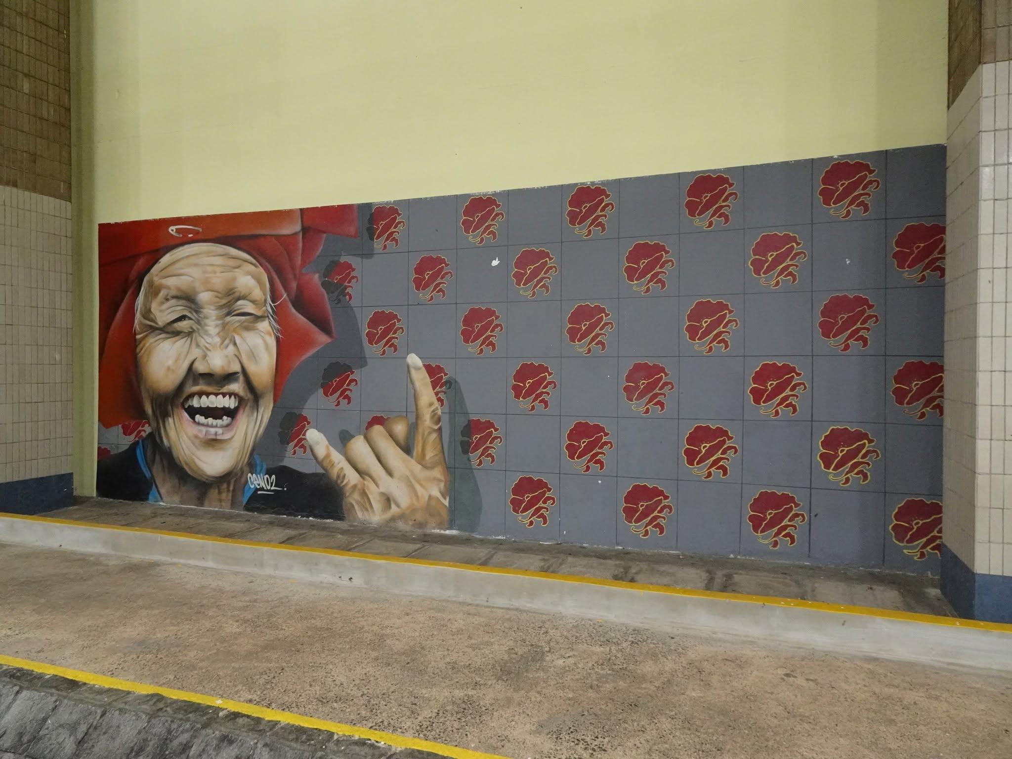 Mural of an auntie doing the metal hand sign, at the Amoy Street Food Centre, Singapore.
