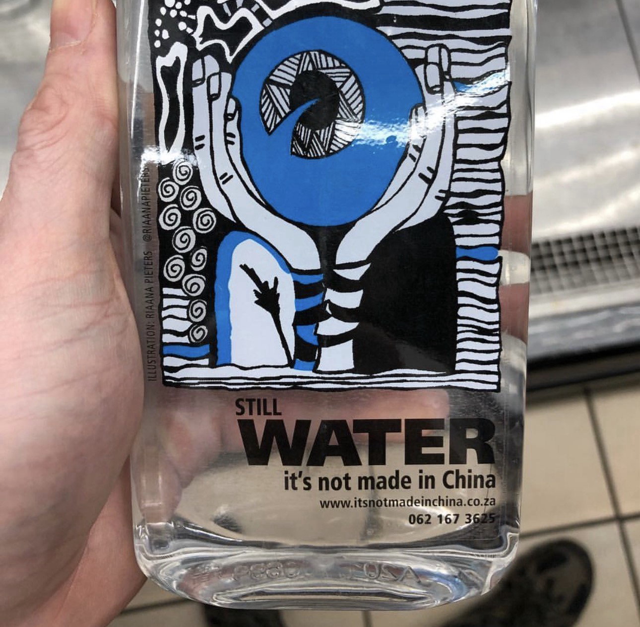 Packer water with picture depicting underwater with written texts STILL WATER NOT MADE IN CHINA