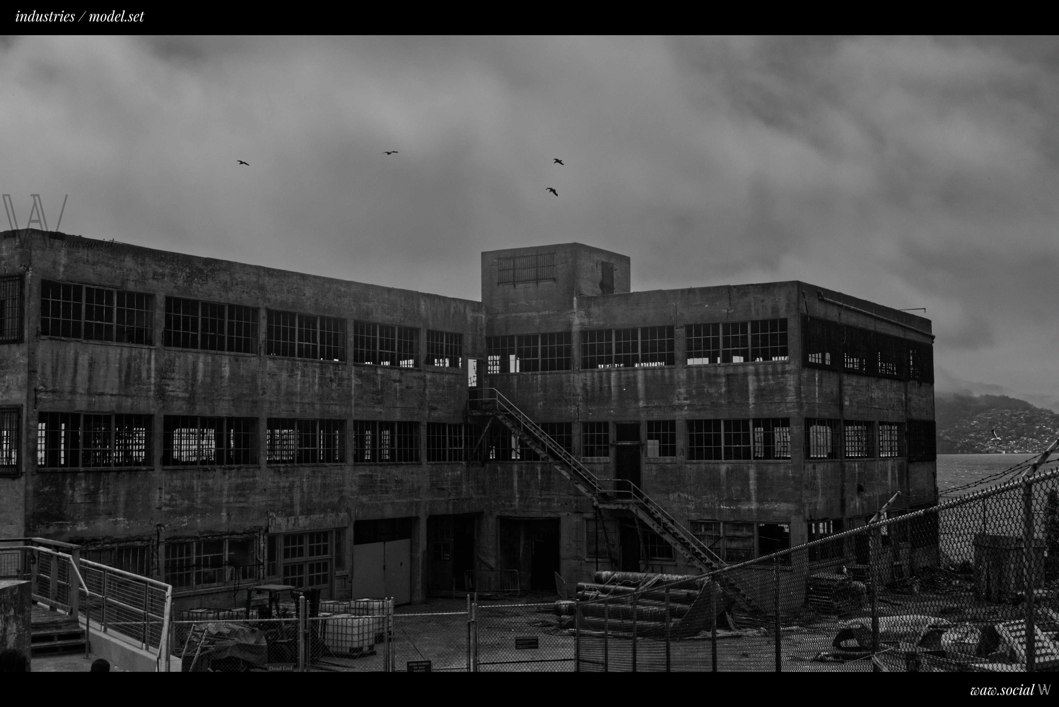 A black and white photo of the Model Industries Building on Alcatraz Island in the Golden Gate National Recreation Area in San Francisco, California.