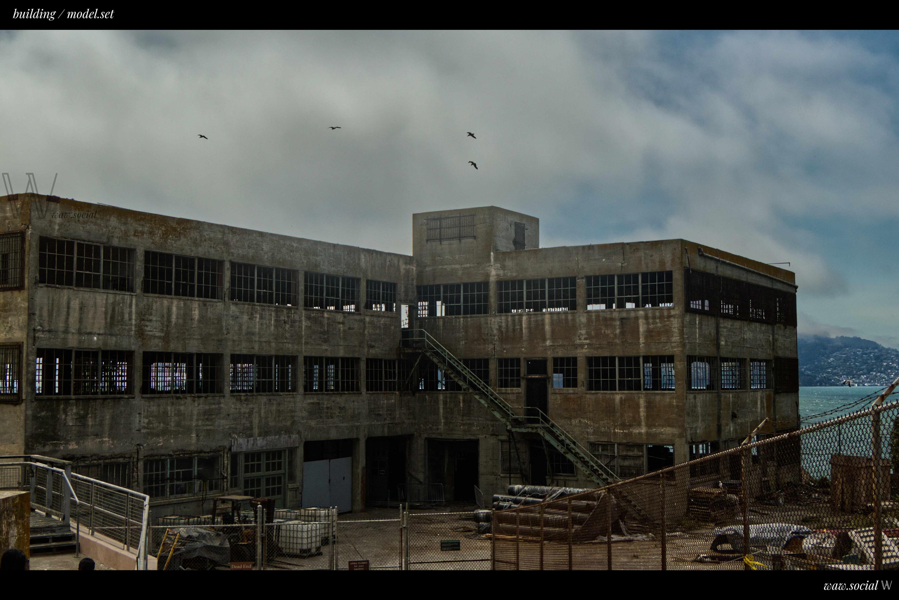A warm color photo of the Model Industries Building on Alcatraz Island in the Golden Gate National Recreation Area in San Francisco, California.