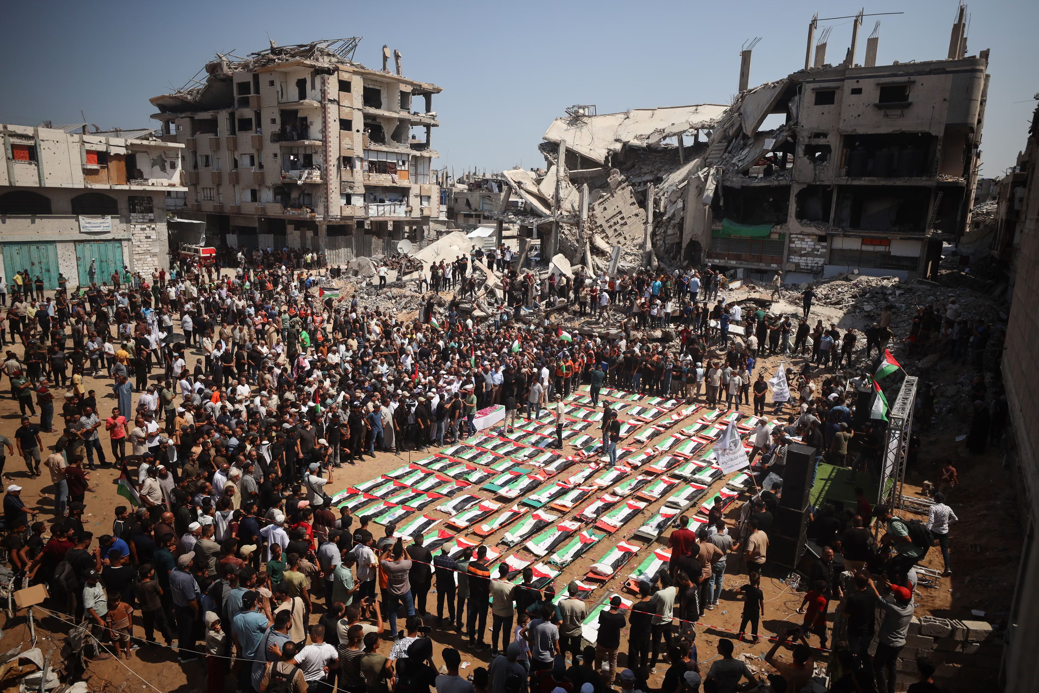 Palestinian mourners attend a mass funeral.