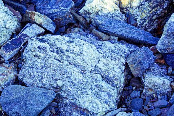 Boulders of Granite by seashore with crystal boundaries etched by weathering by the waves
