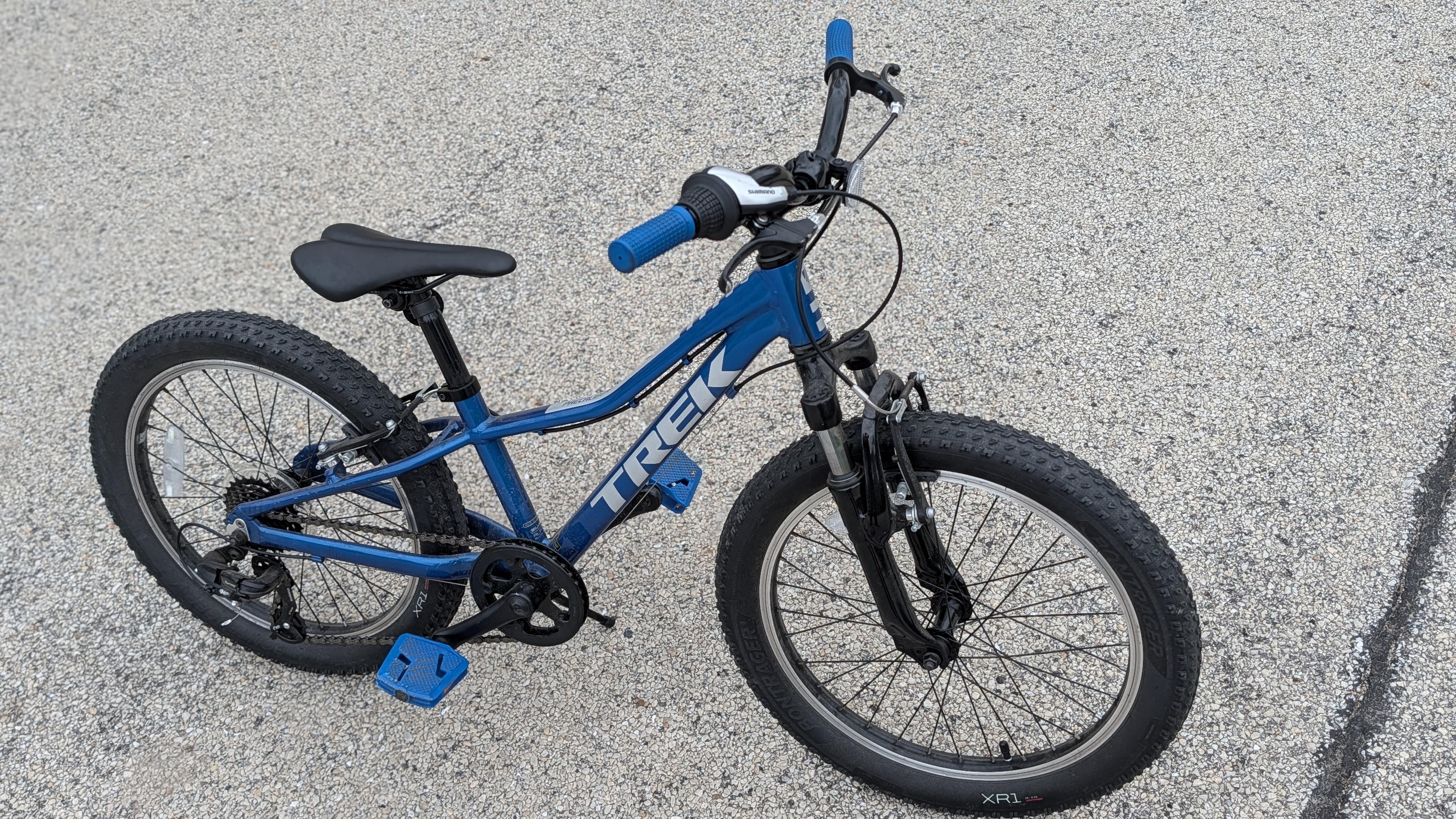 A blue Trek Precalibur youth mountain bike.