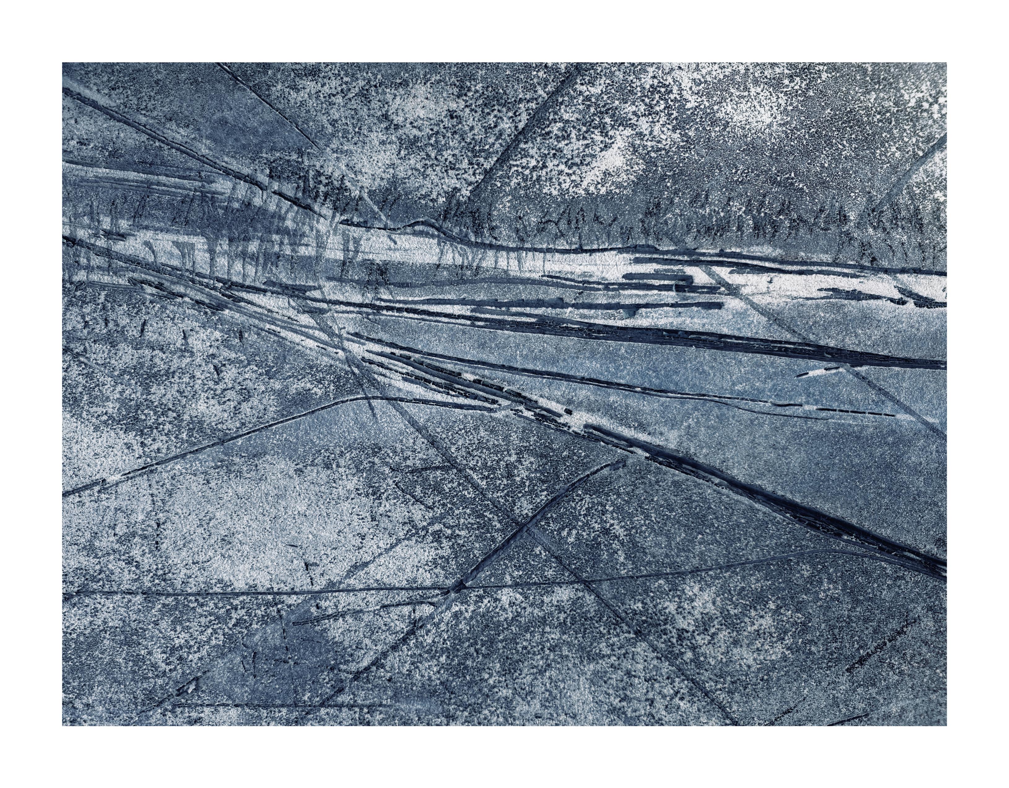 An abstract wall texture with climbing plant indentations that mildly resembles a winter landscape scene.