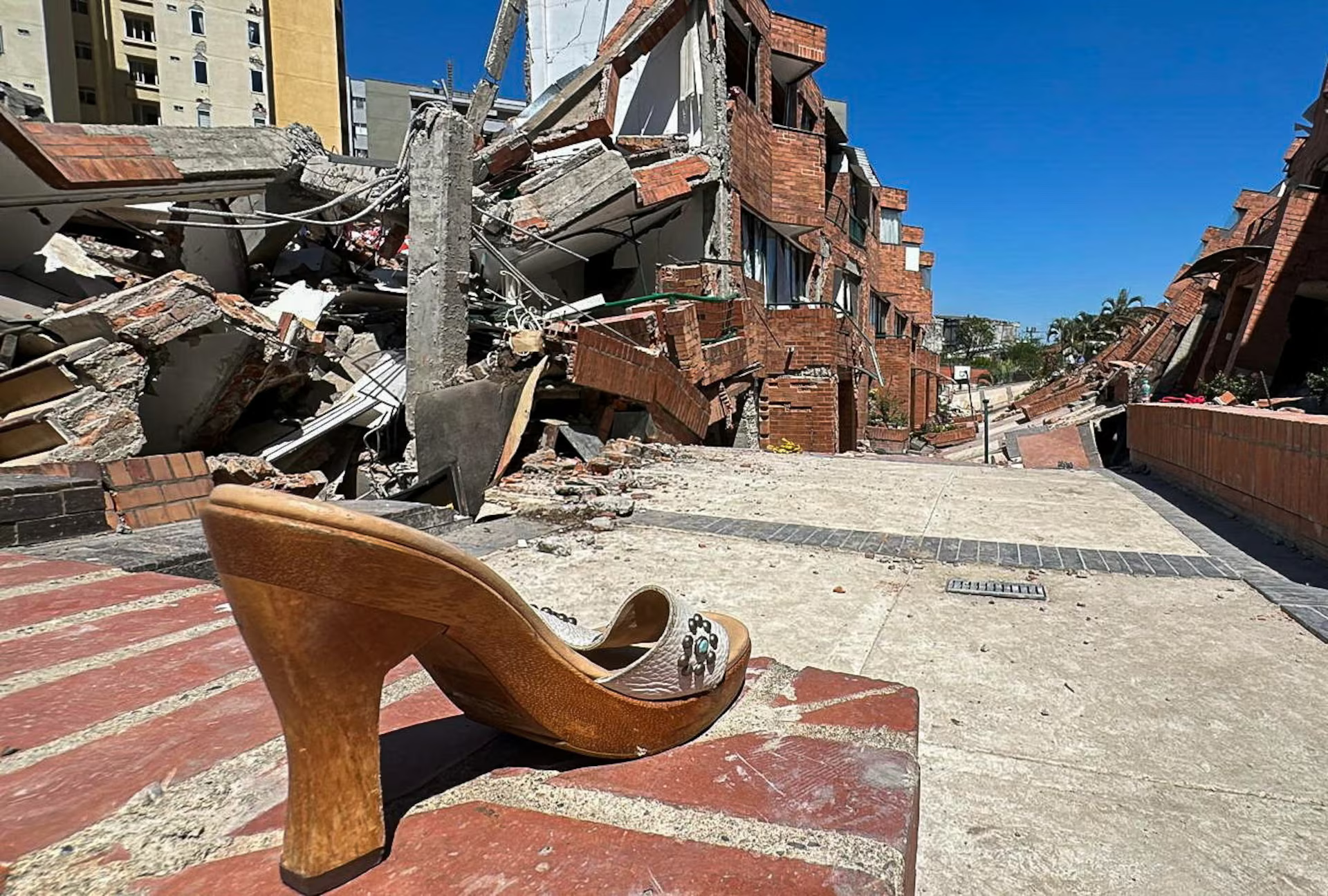 A shoe left behind and collapsed buildings in Cali, Colombia.