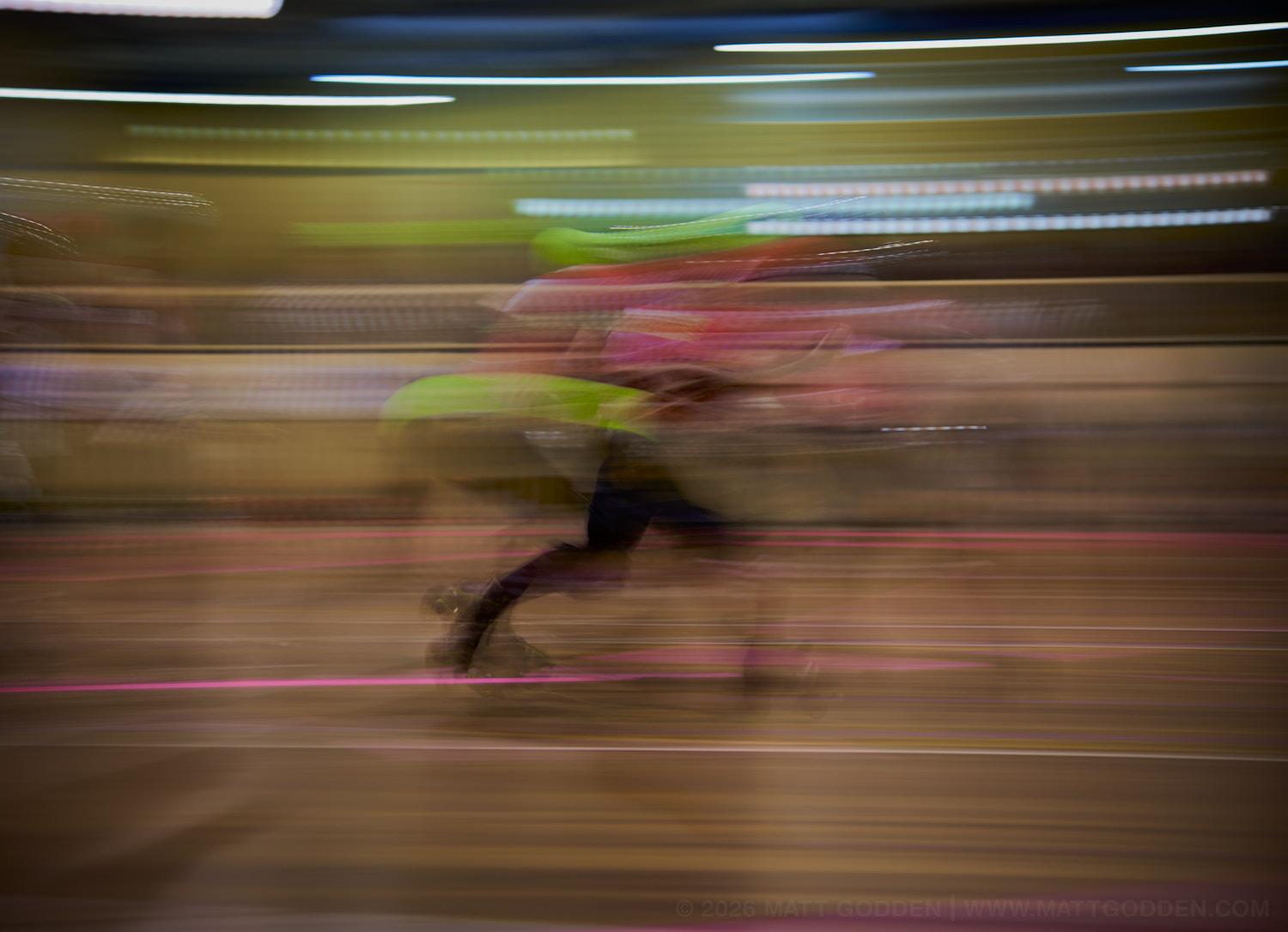 A long exposure image of roller derby competitors from the D'Viants (lime green), and the Screaming Assault Sirens (red). 2013/11/09