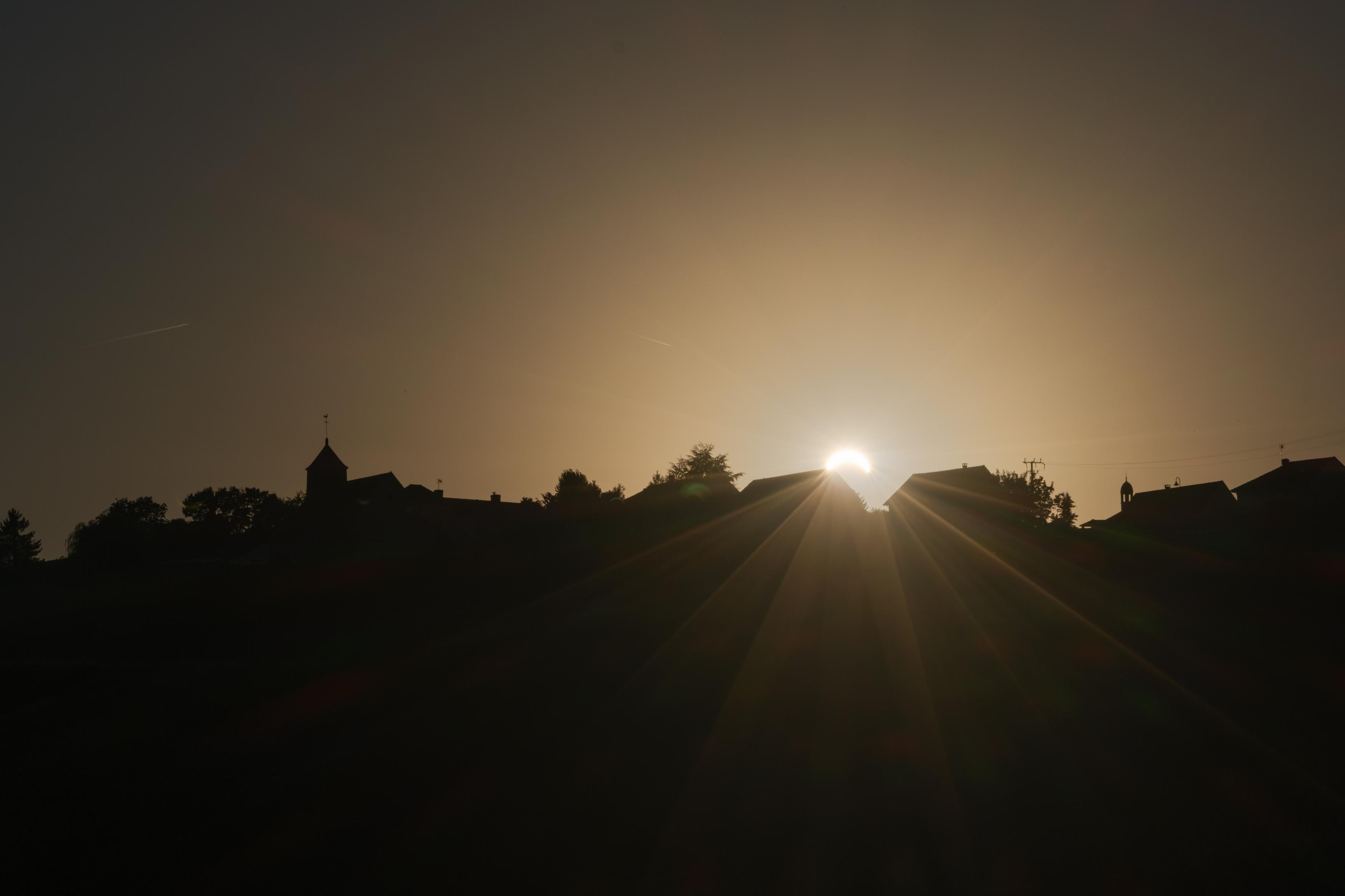 Solar eclipse above a little town in the Montagne de Reims - Champagne