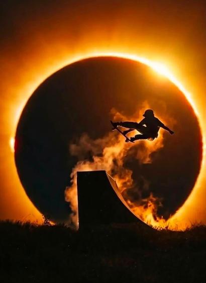 …
…
Crap that’s amazing
Oh right, the AltText;
Truly phenomenal shot showing a full solar eclipse on the horizon with the edge of the sun just bursting out from the upper right hand corner over the darkened moon
In front of the sun, a skateboard ramp has been set up and hovering in mid air is a skateboarder in silhouette wreathed in dust giving the illusion of a flaming aura as it is illuminated by the sunlight streaming around the moon, the dust leading up from the ramp and surrounding the ska…
