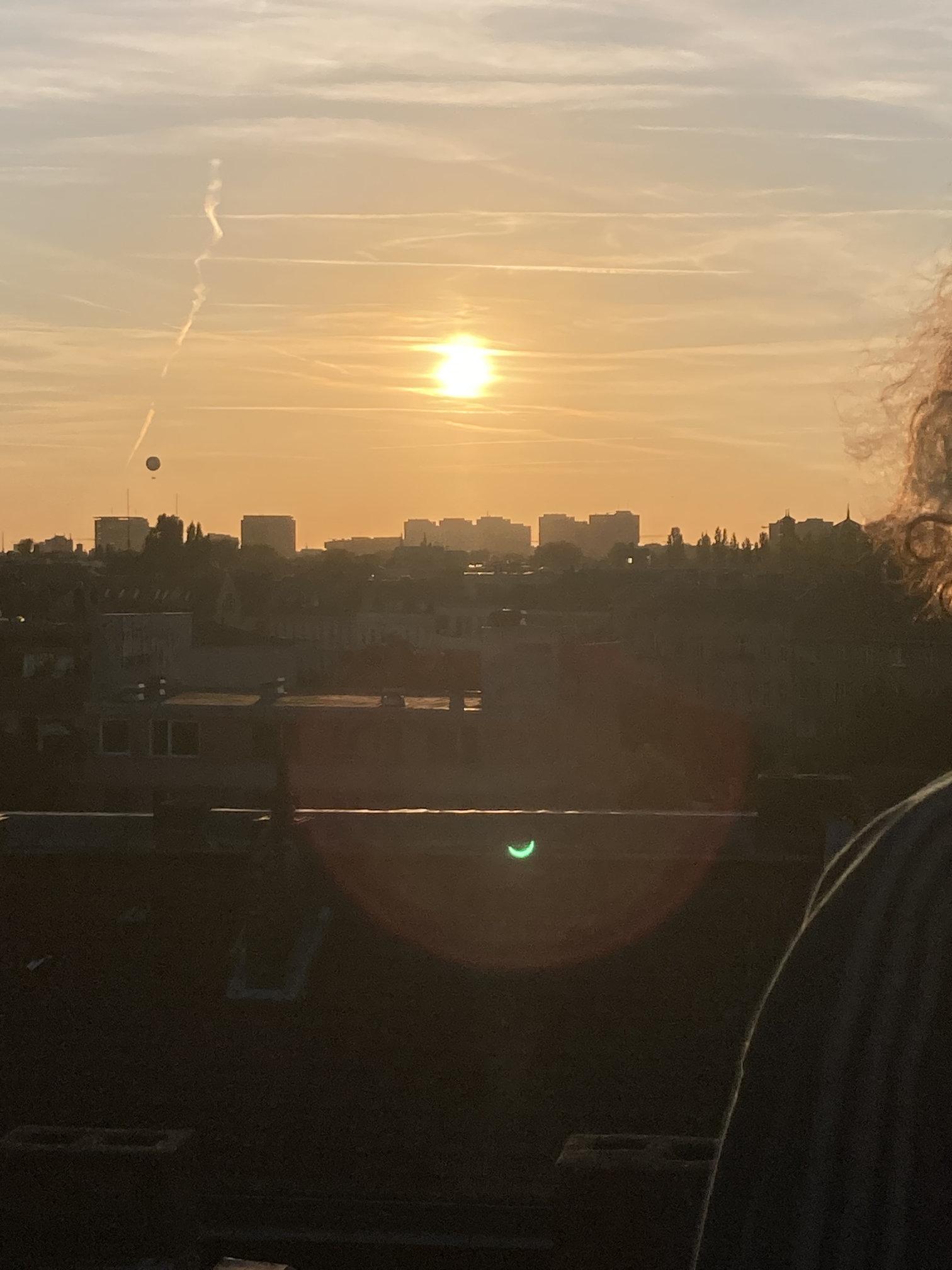 similar scene, but with a tethered balloon over the horizon and a curly person cropped out at the other side